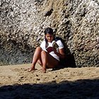 girl reading on rock